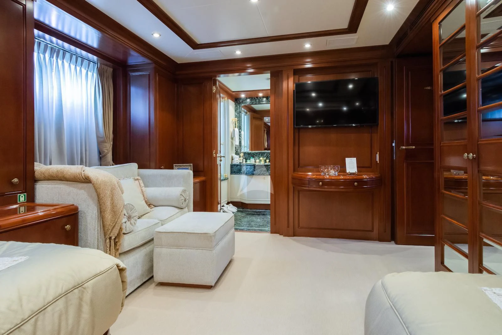 a room with a bed and a couch aboard APOGEE Yacht for Sale