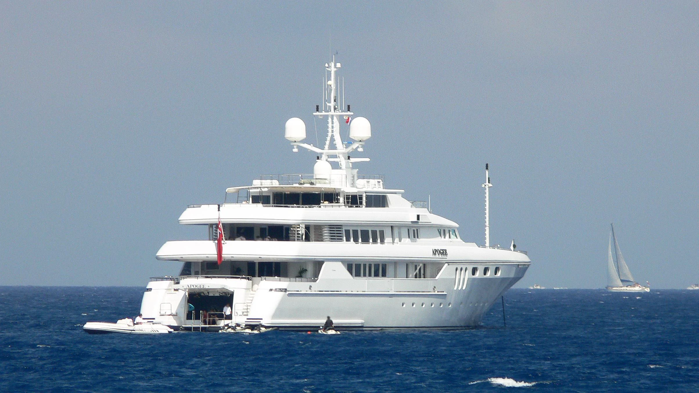 a large white boat in the water aboard APOGEE Yacht for Sale