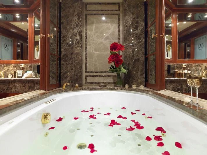 a bathroom with a bathtub and a sink aboard APOGEE Yacht for Sale