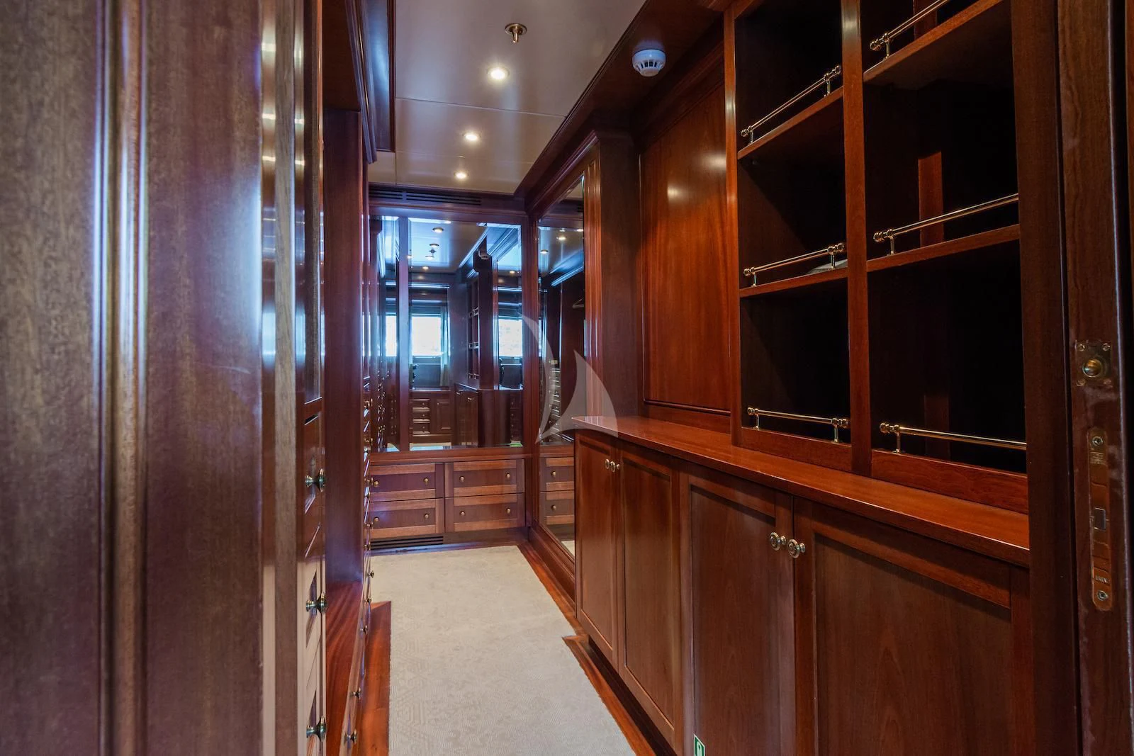 a room with wooden cabinets aboard APOGEE Yacht for Sale
