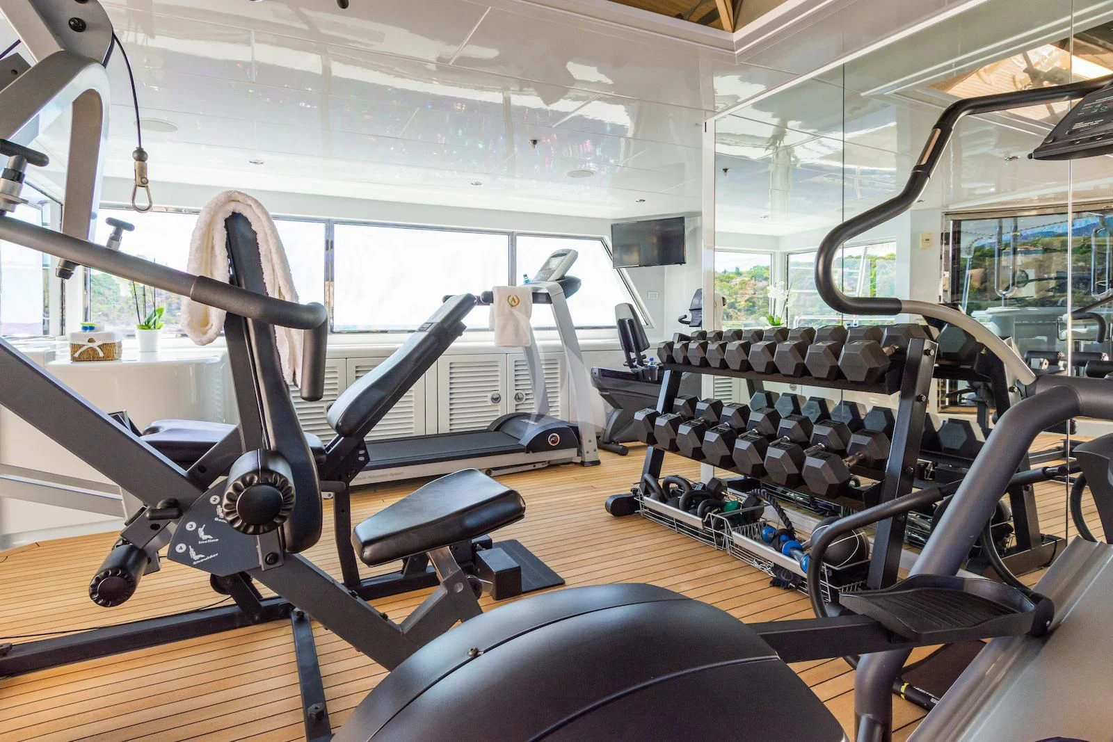 a room with a large window and a large gym with large windows aboard APOGEE Yacht for Sale