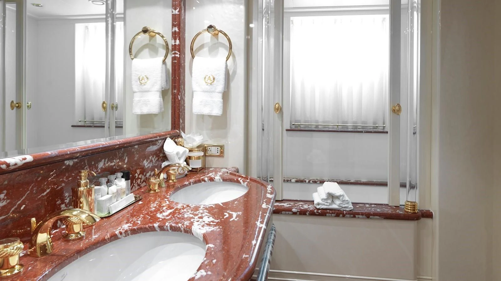 a bathroom with a sink and bathtub aboard APOGEE Yacht for Sale