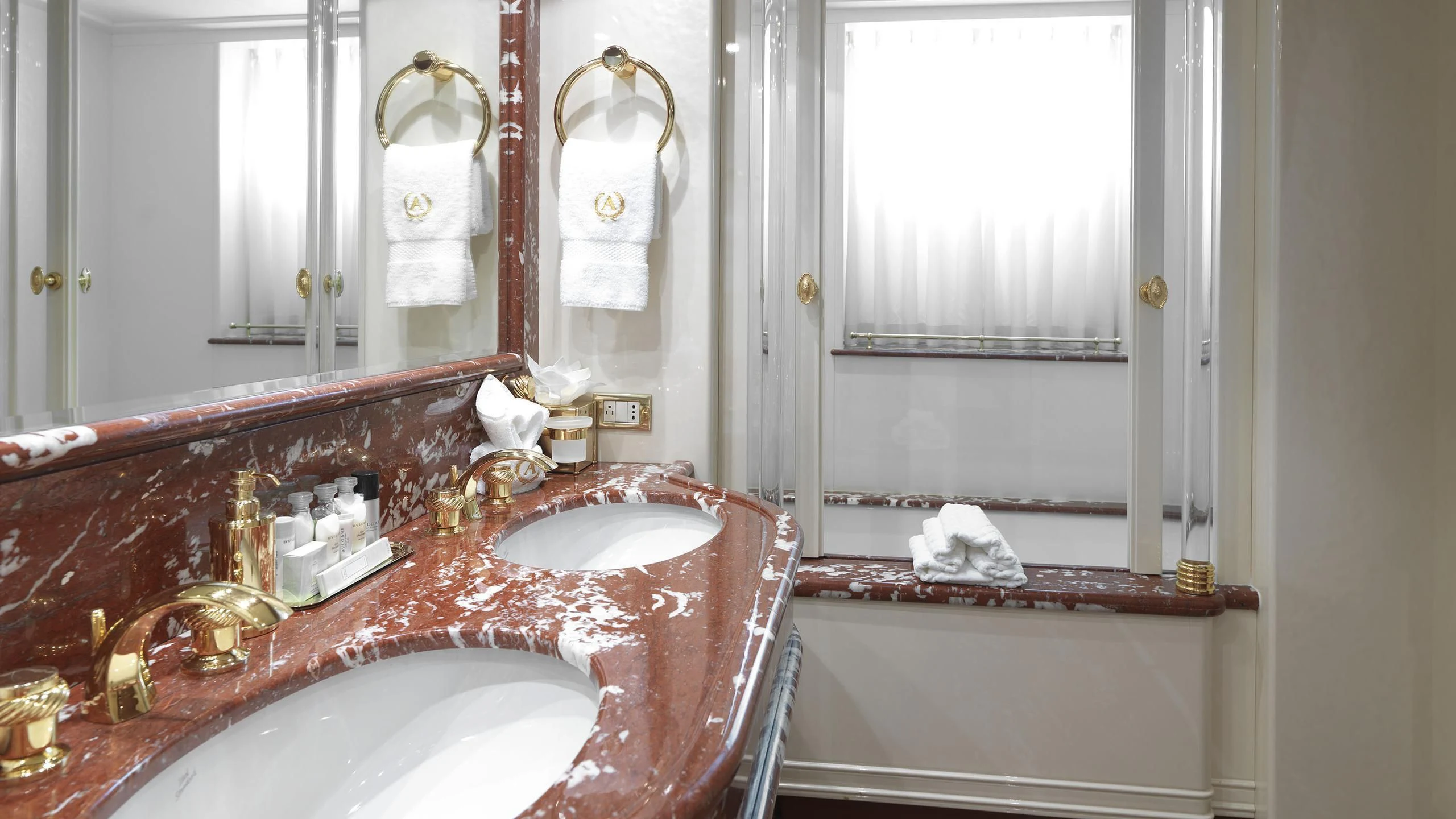 a bathroom with a sink and bathtub aboard APOGEE Yacht for Sale