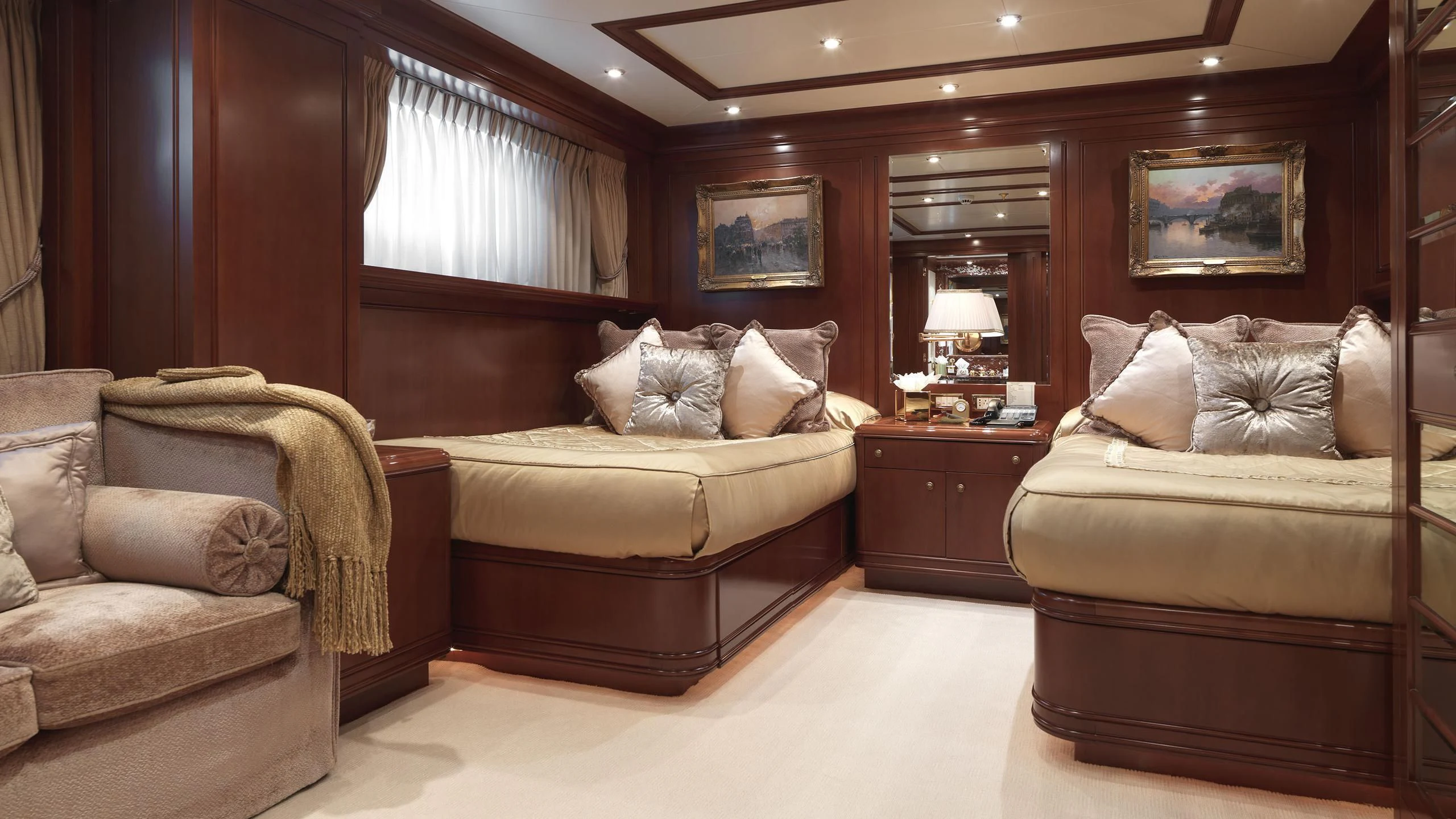 a room with a bed and a couch aboard APOGEE Yacht for Sale