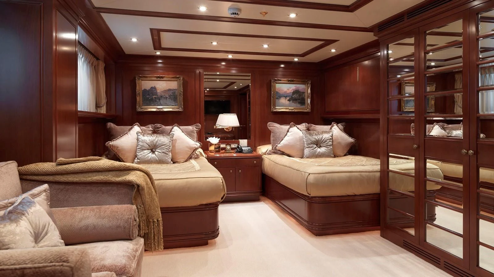 a room with a bed and a couch aboard APOGEE Yacht for Sale