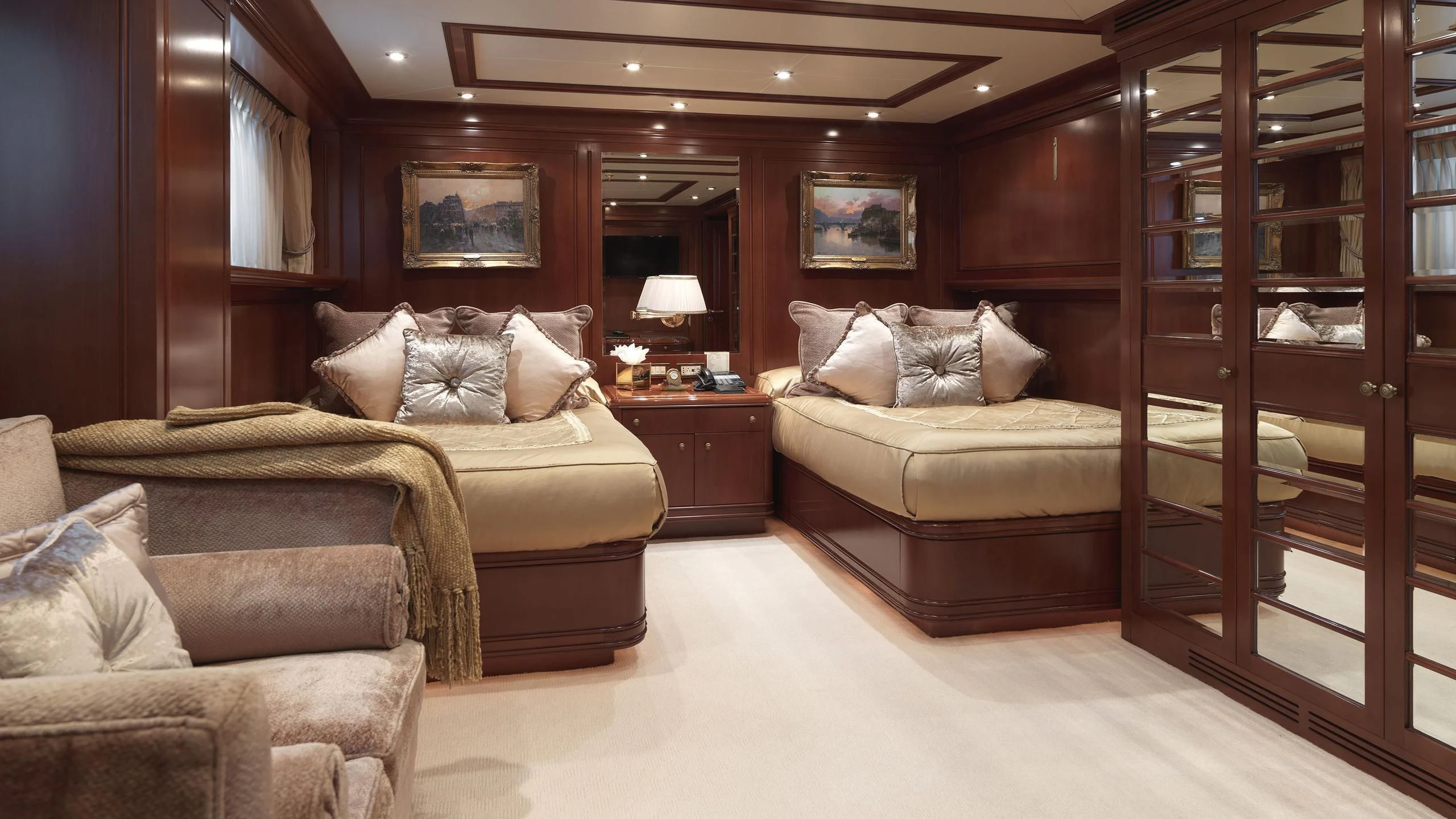 a room with a bed and a couch aboard APOGEE Yacht for Sale