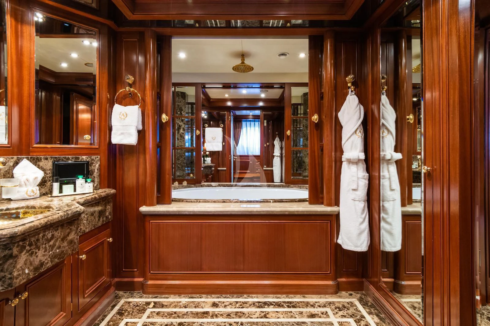 a bathroom with a large mirror aboard APOGEE Yacht for Sale