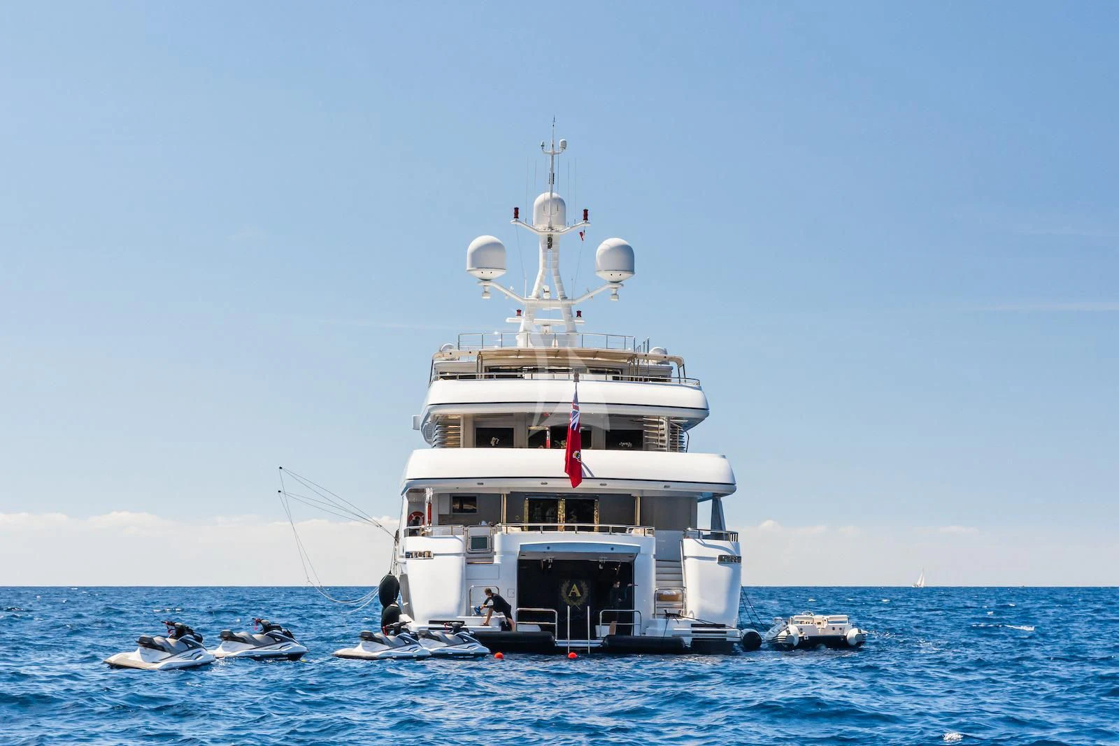 a large white boat in the water aboard APOGEE Yacht for Sale