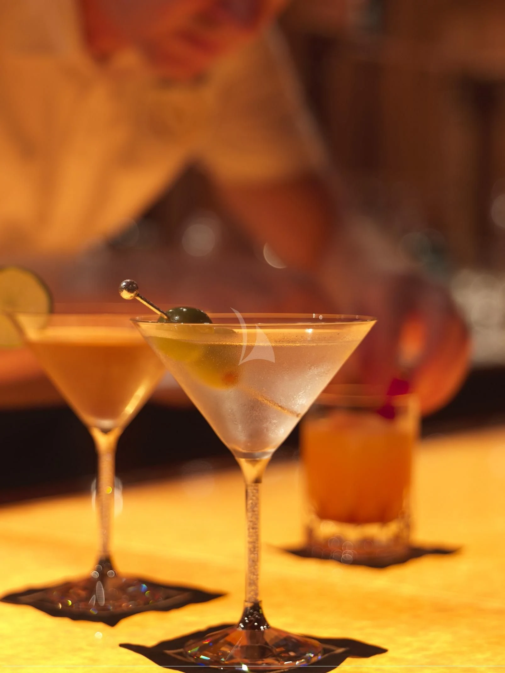 a group of glasses with drinks aboard APOGEE Yacht for Sale