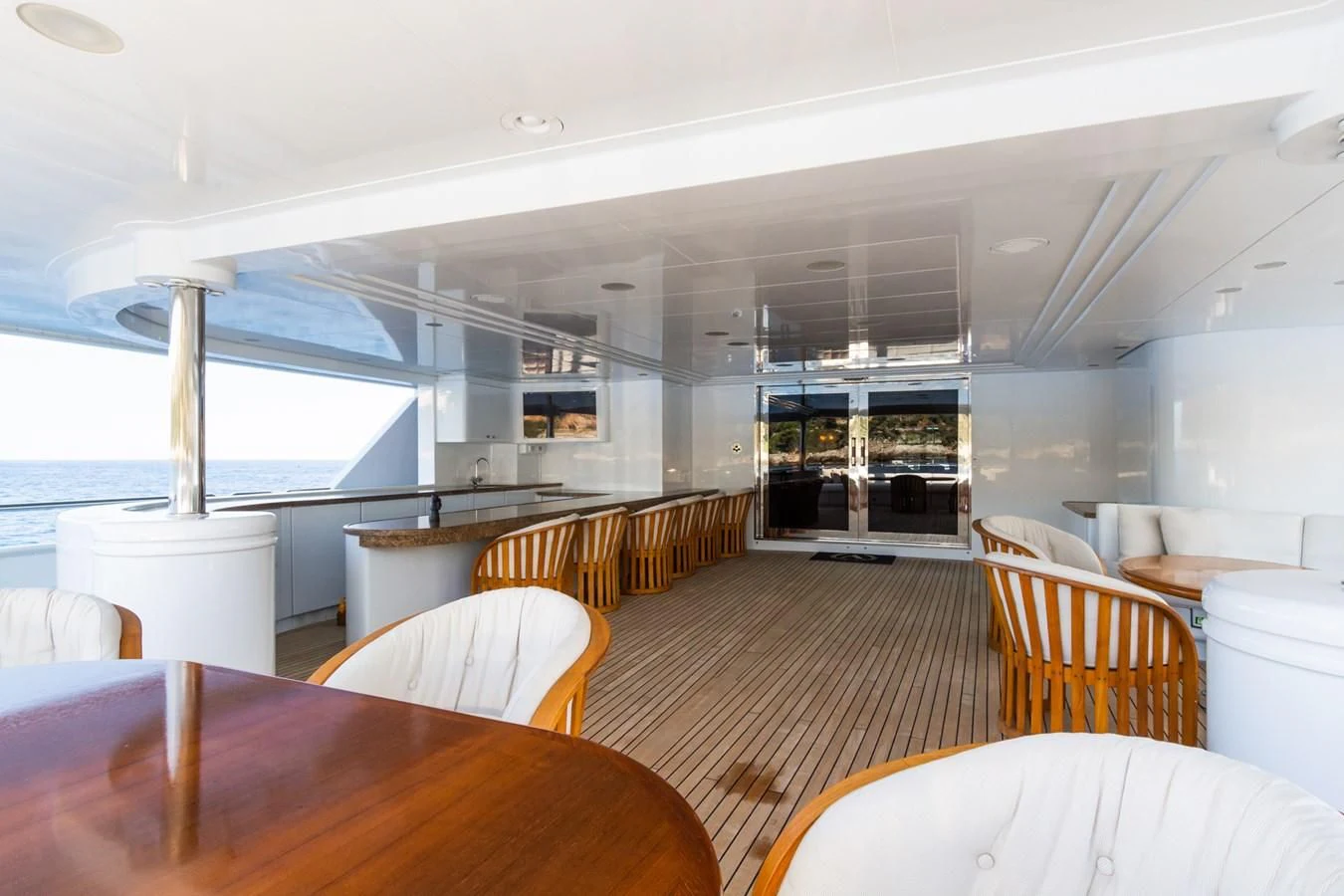 a large room with tables and chairs aboard APOGEE Yacht for Sale