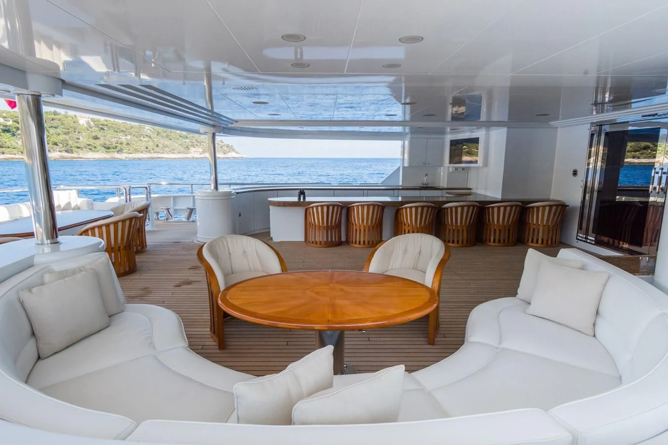 a living room with a large table and chairs aboard APOGEE Yacht for Sale