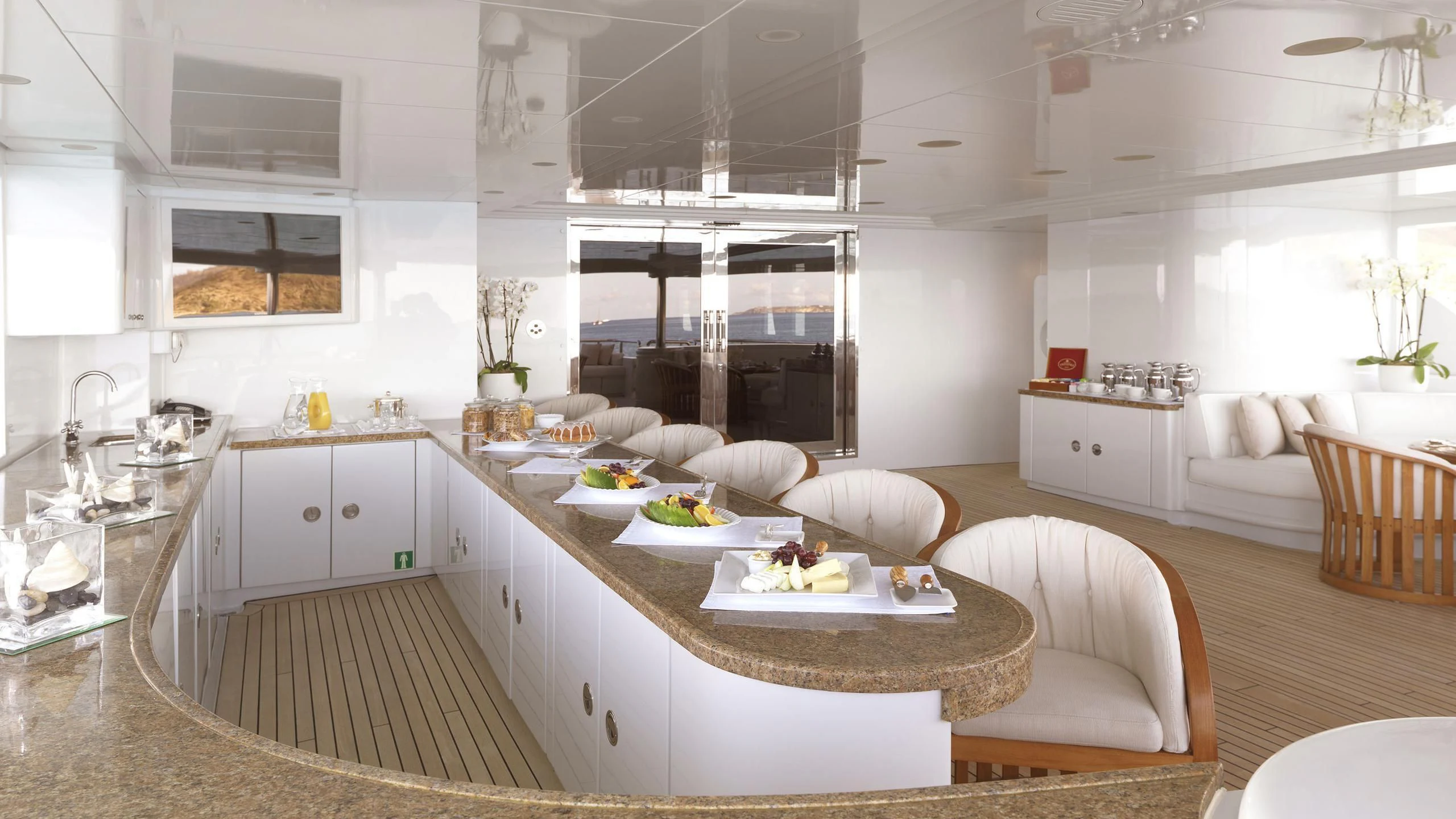 a large kitchen with a dining table aboard APOGEE Yacht for Sale
