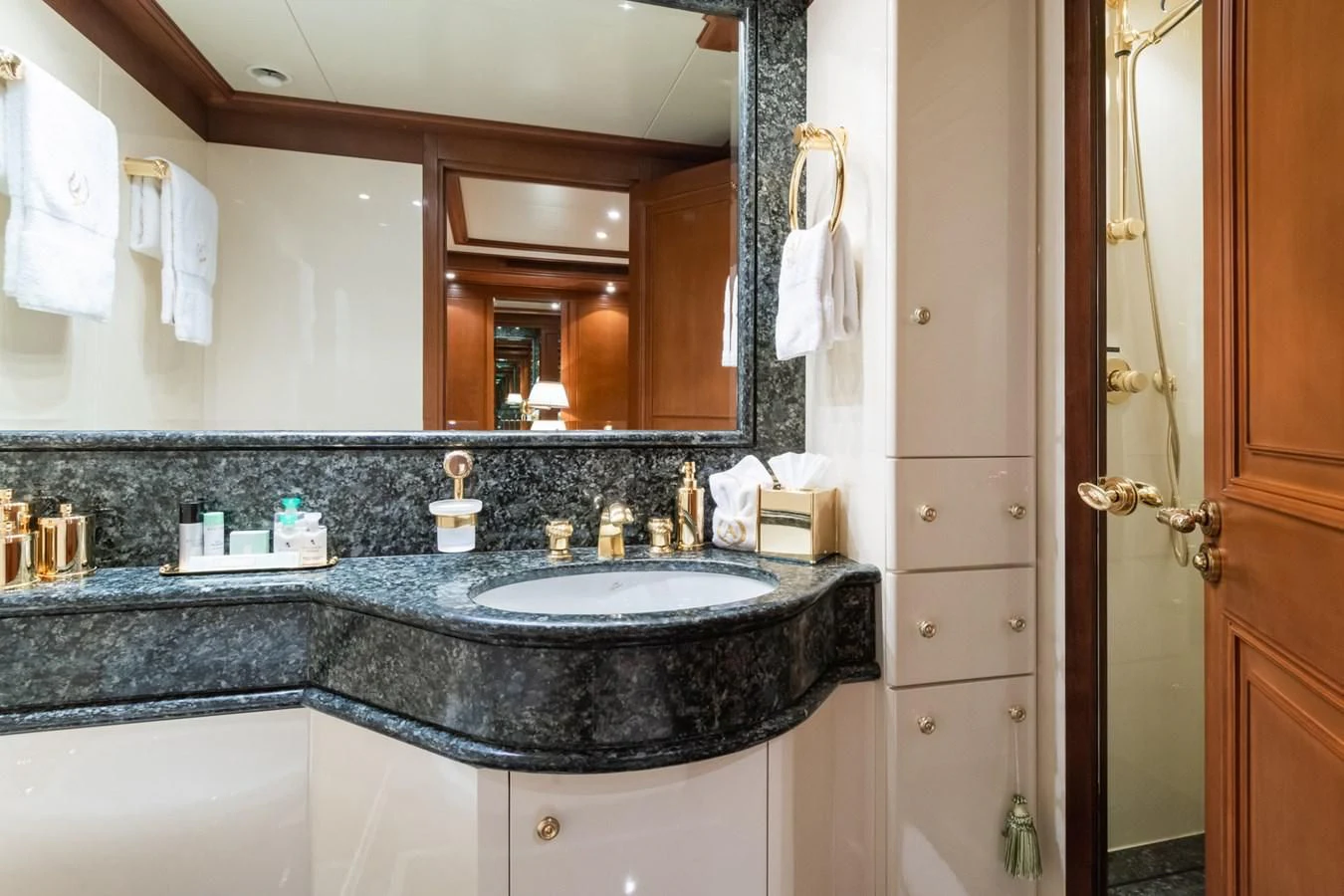 a bathroom with a countertop sink and mirror aboard APOGEE Yacht for Sale