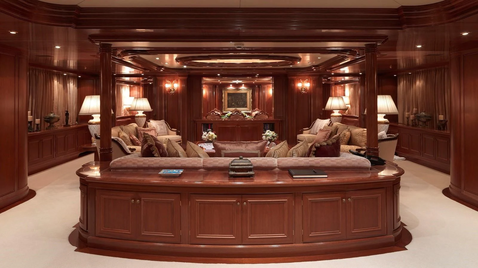 a large living room with a large wood table aboard APOGEE Yacht for Sale