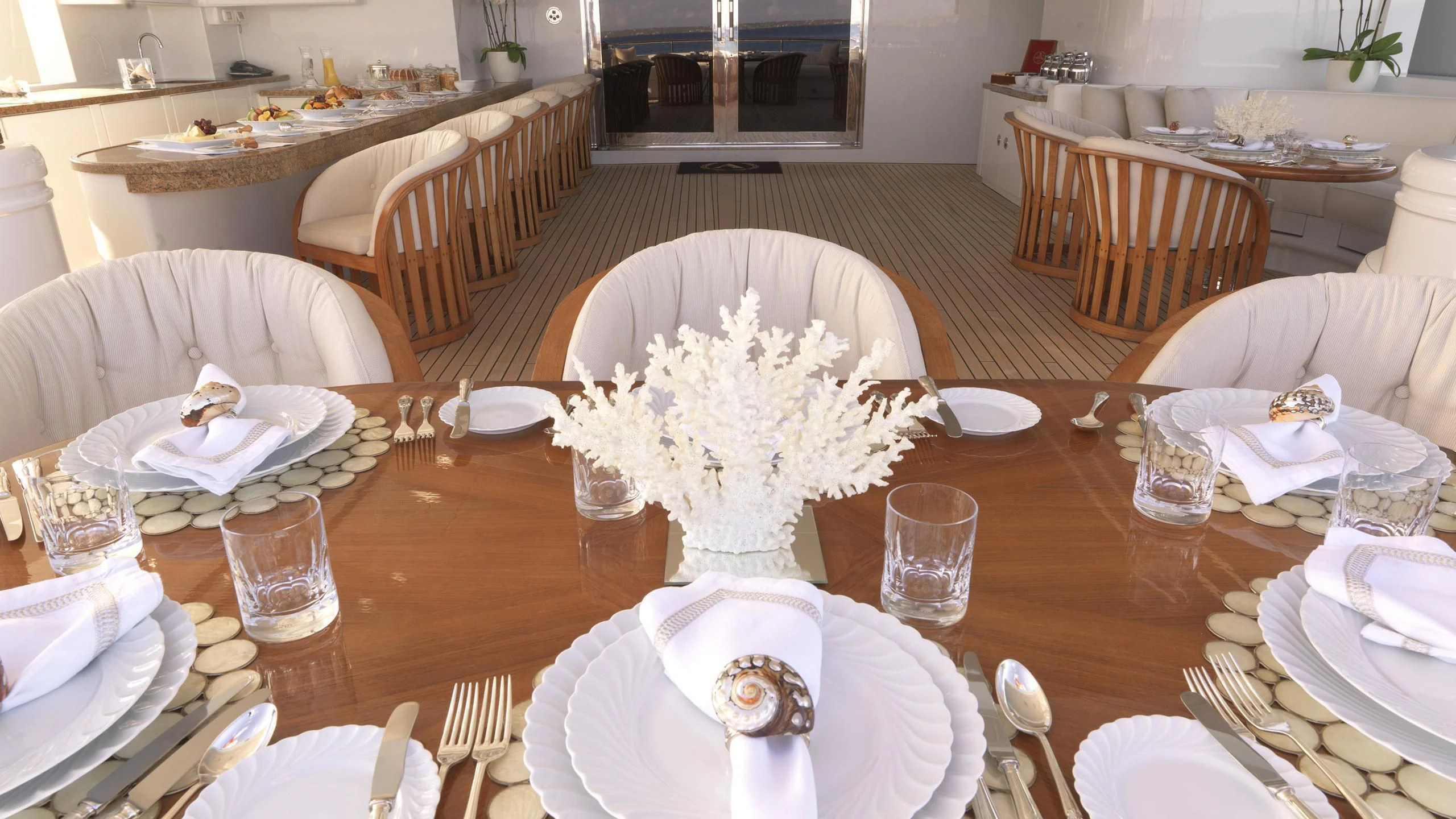 a table with plates and silverware aboard APOGEE Yacht for Sale