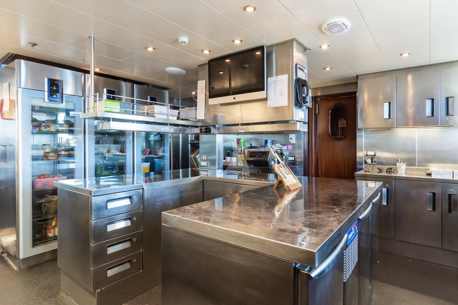 a kitchen with a large island aboard APOGEE Yacht for Sale