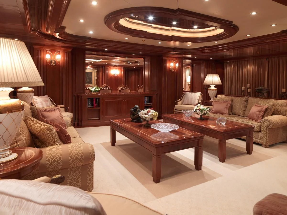 a living room with a large chandelier aboard APOGEE Yacht for Sale