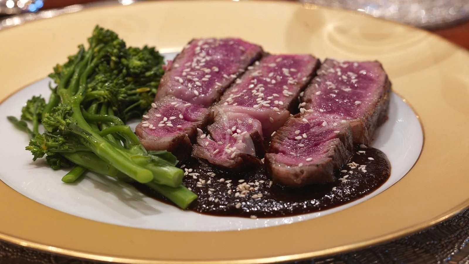 a plate of steak and broccoli aboard APOGEE Yacht for Sale