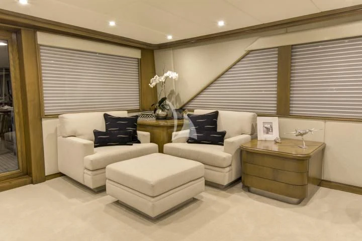 a living room with white furniture aboard SERENITY Yacht for Charter