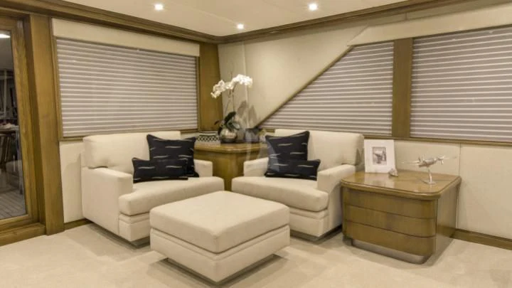 a living room with a couch and a coffee table aboard SERENITY Yacht for Charter