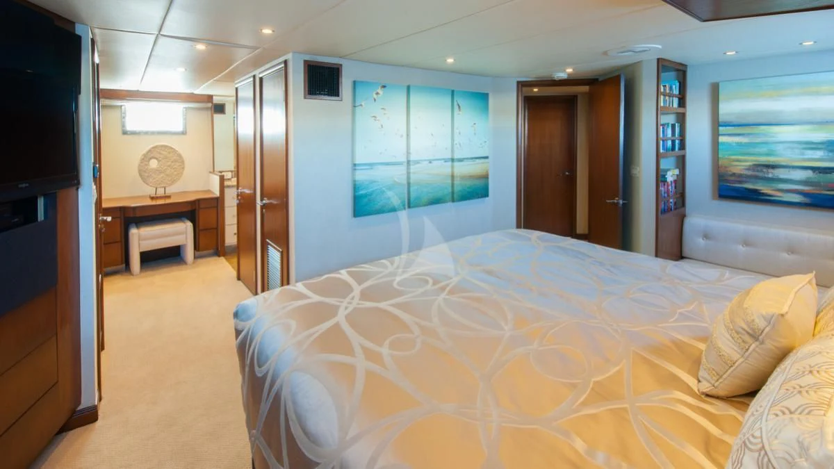 a bedroom with a bed and a tv aboard SERENITY Yacht for Charter