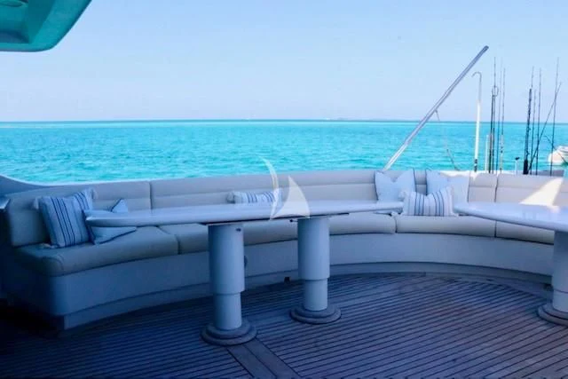 a white lounge chair on a deck overlooking the ocean aboard SERENITY Yacht for Charter