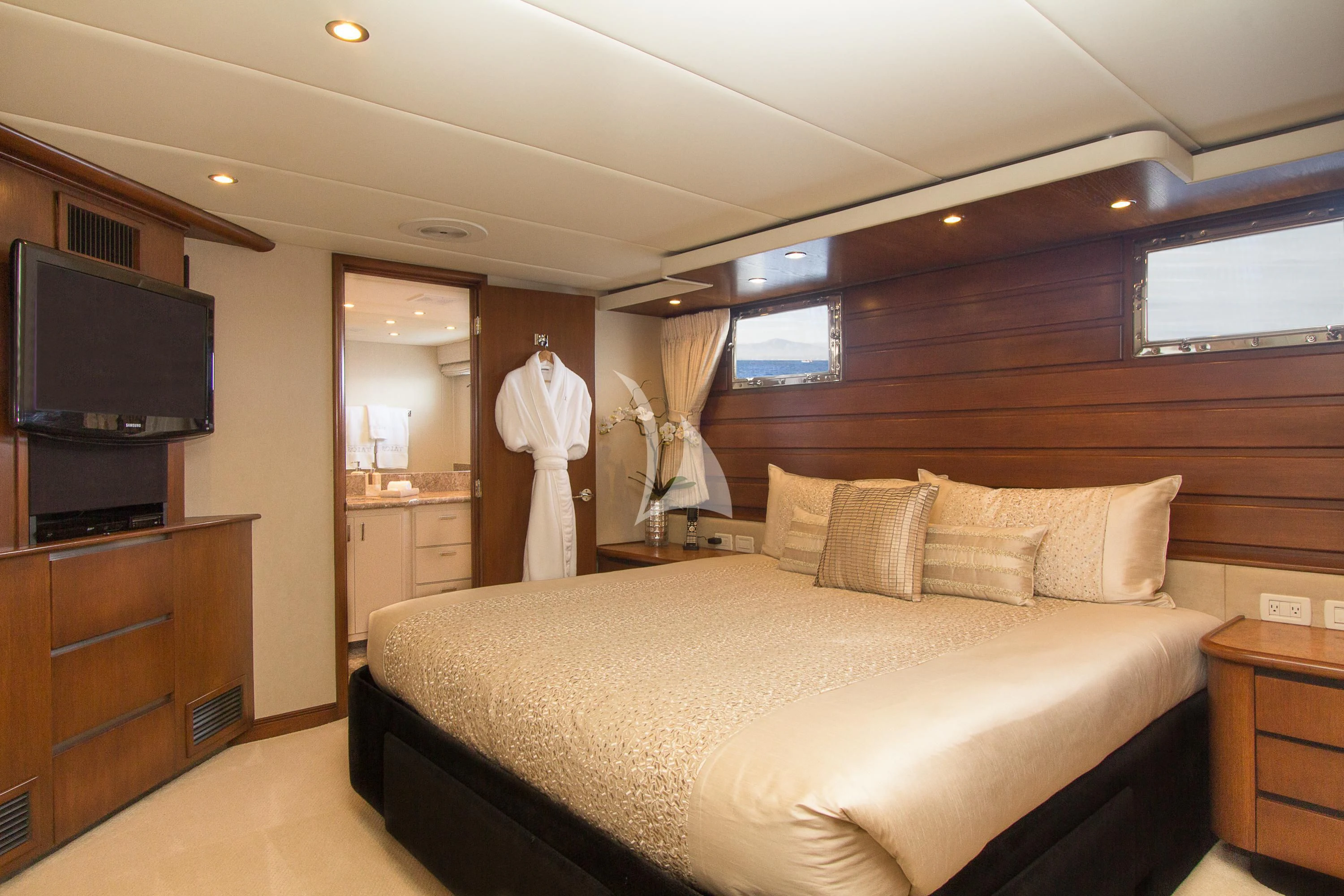 a bedroom with a bed and a television aboard SERENITY Yacht for Charter