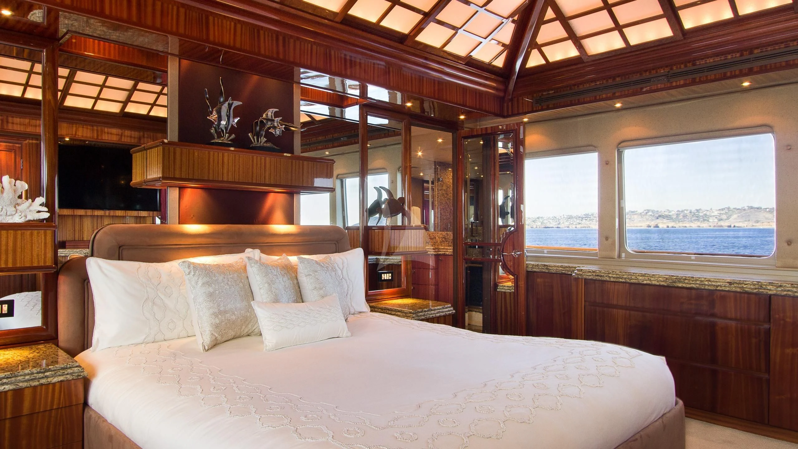 a bed with white sheets aboard SERENITY Yacht for Charter