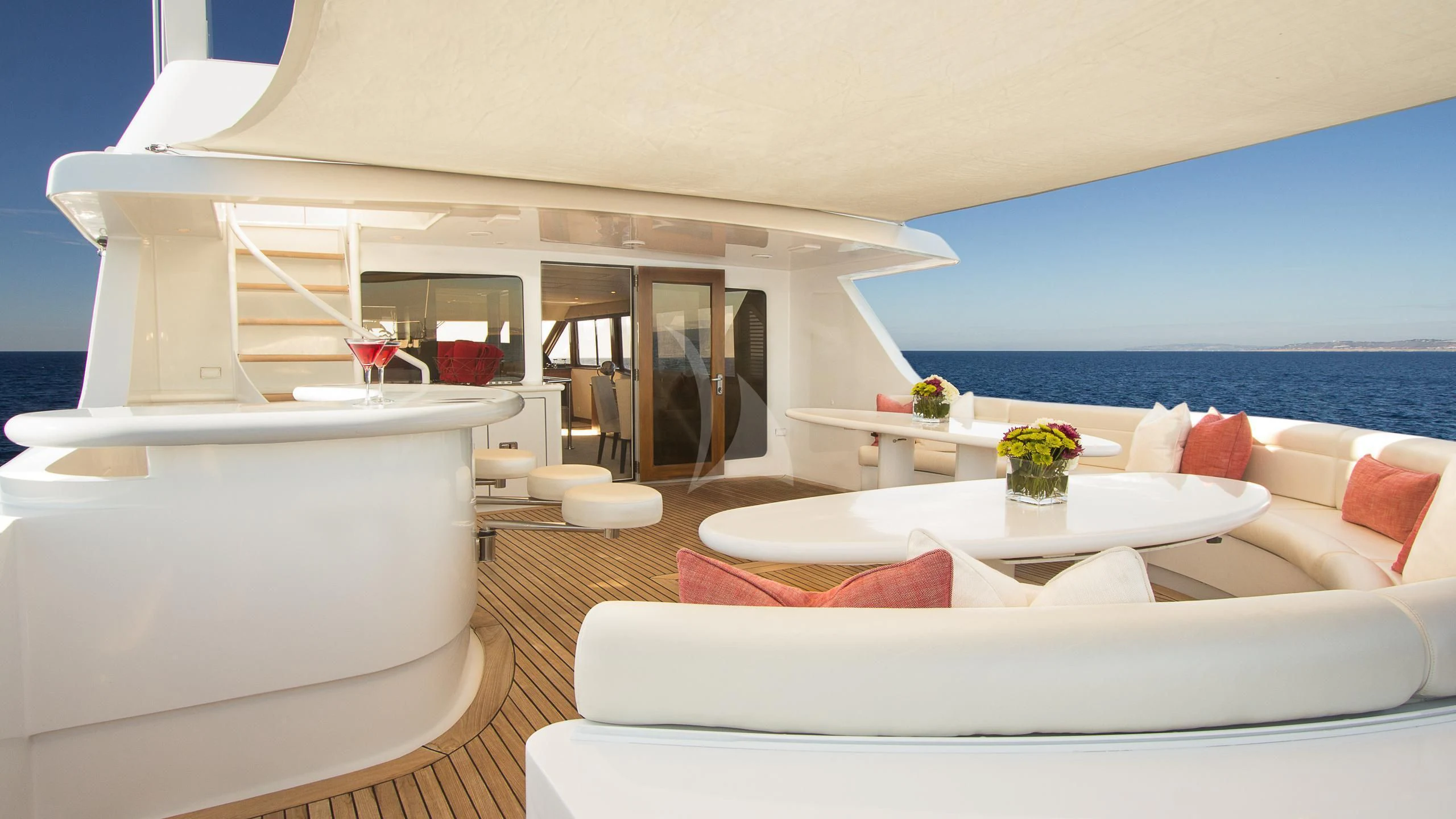 a living room with a large white sofa and a large body of water aboard SERENITY Yacht for Charter