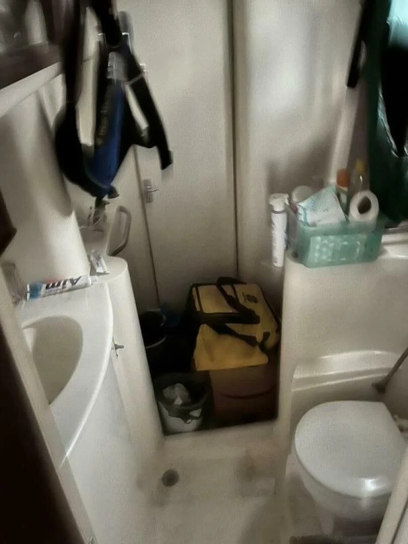 a bathroom with a toilet and sink aboard SERENITY Yacht for Charter