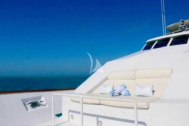 a white boat with a blue sky aboard SERENITY Yacht for Charter