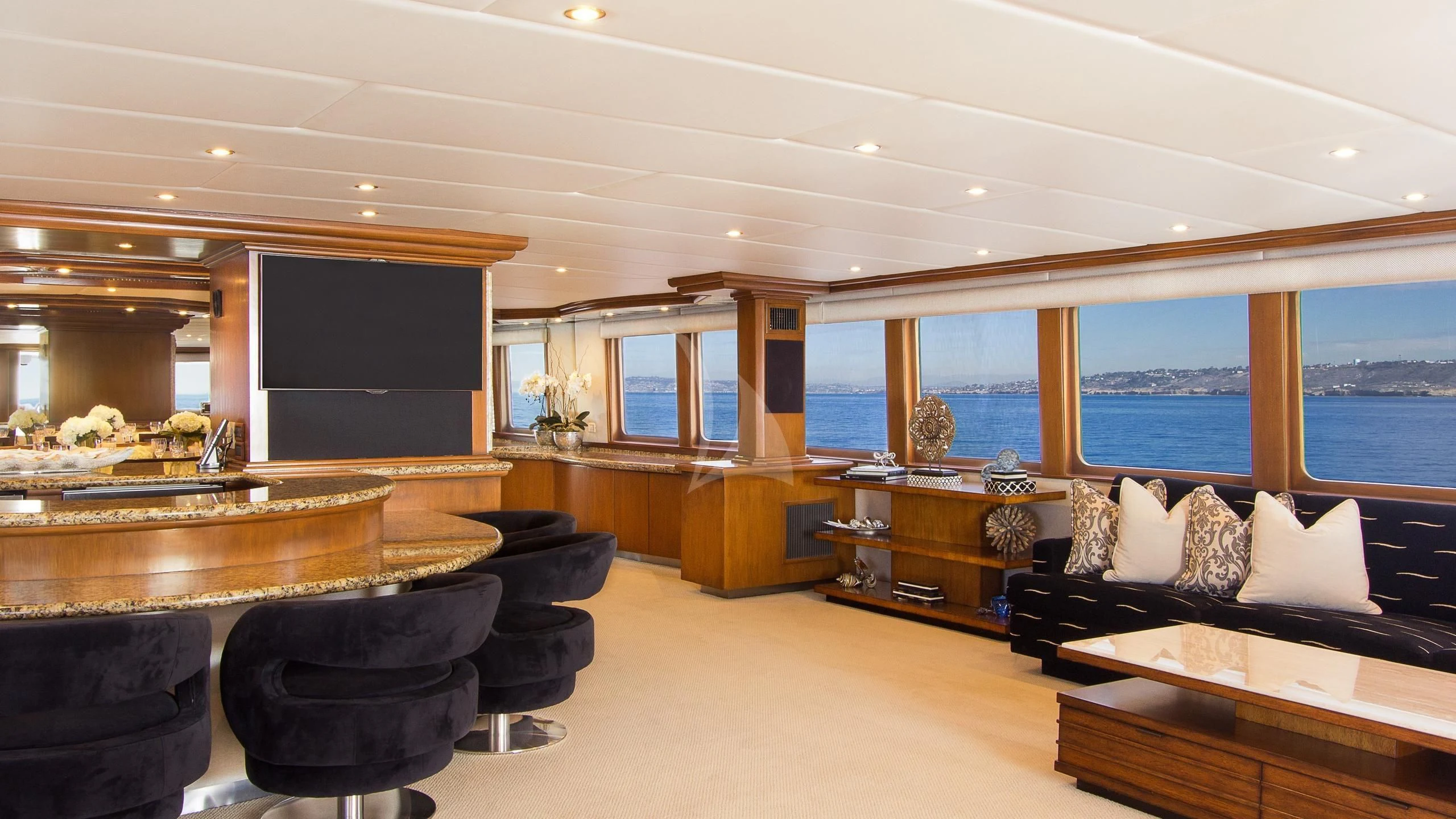 a room with a tv and a couch aboard SERENITY Yacht for Charter