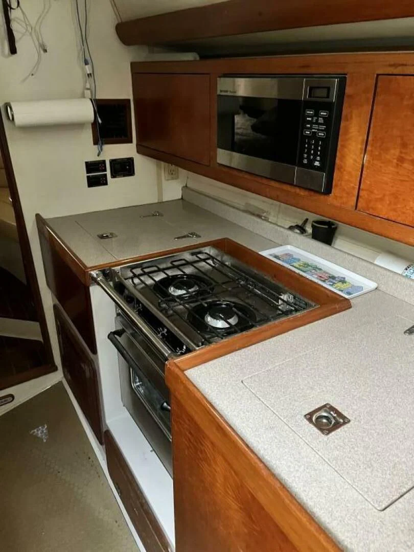 a kitchen with a stove and microwave aboard SERENITY Yacht for Charter