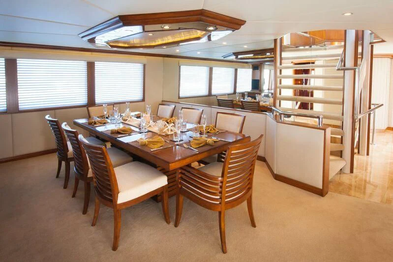 a dining room with a table and chairs aboard SERENITY Yacht for Charter