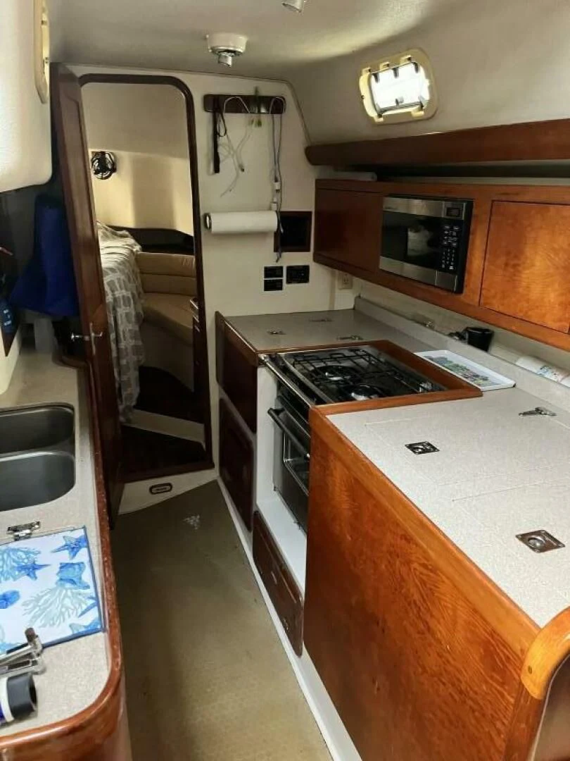 a kitchen with a stove and sink aboard SERENITY Yacht for Charter