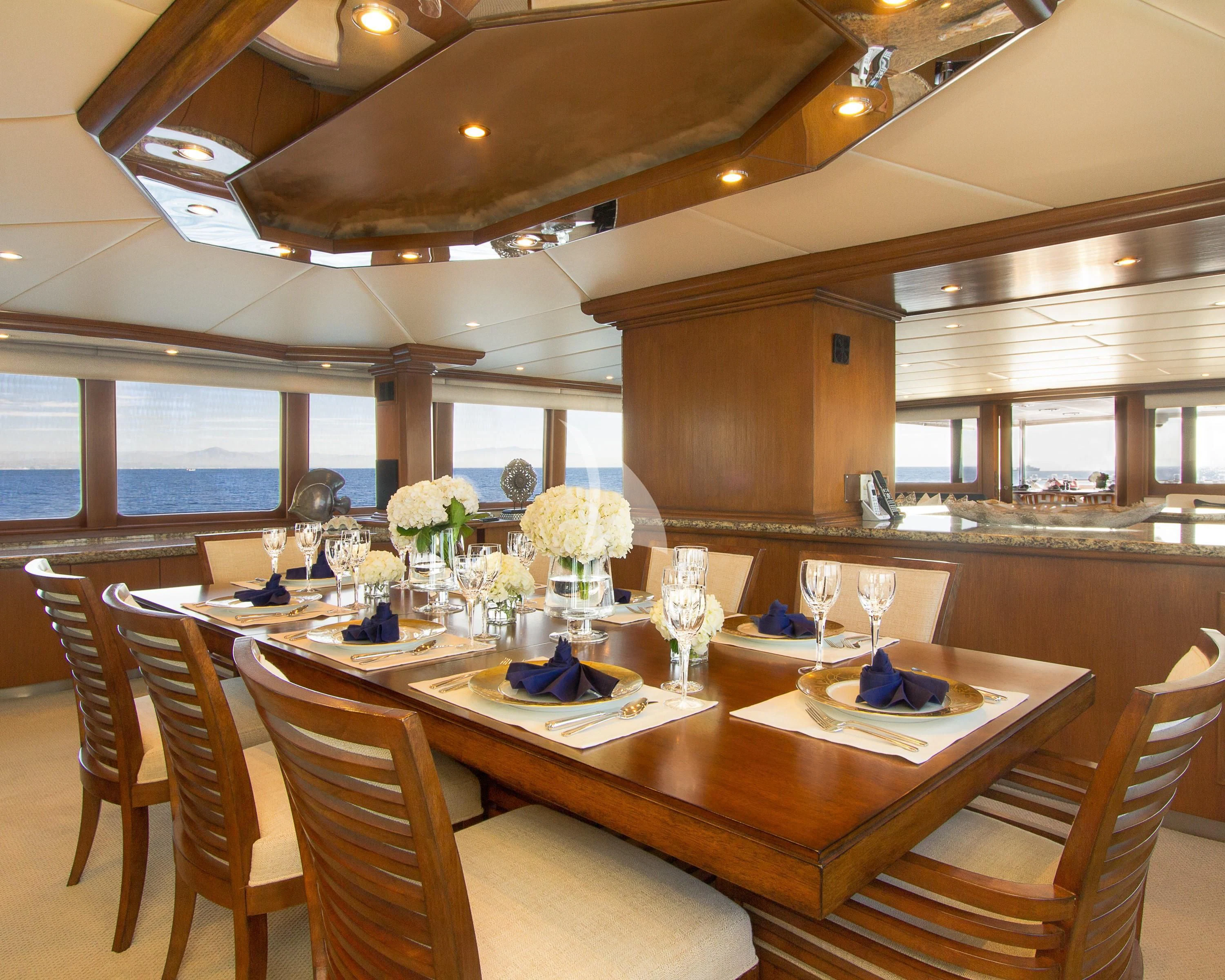 a dining room with a table set aboard SERENITY Yacht for Charter