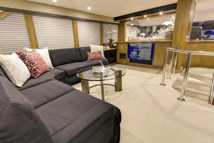 a living room with a couch and a coffee table aboard SERENITY Yacht for Charter
