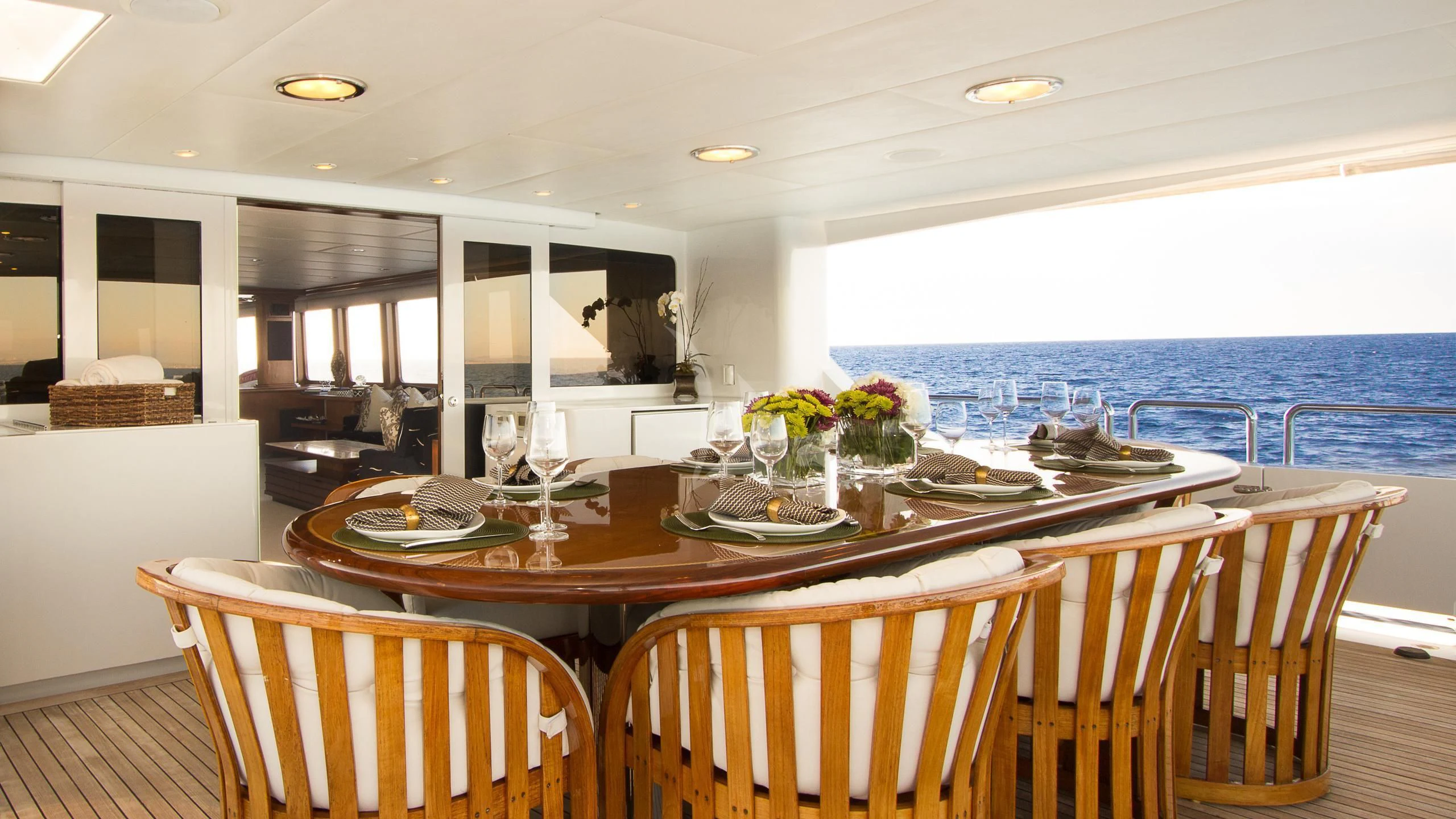 a dining table with a view of the ocean aboard SERENITY Yacht for Charter