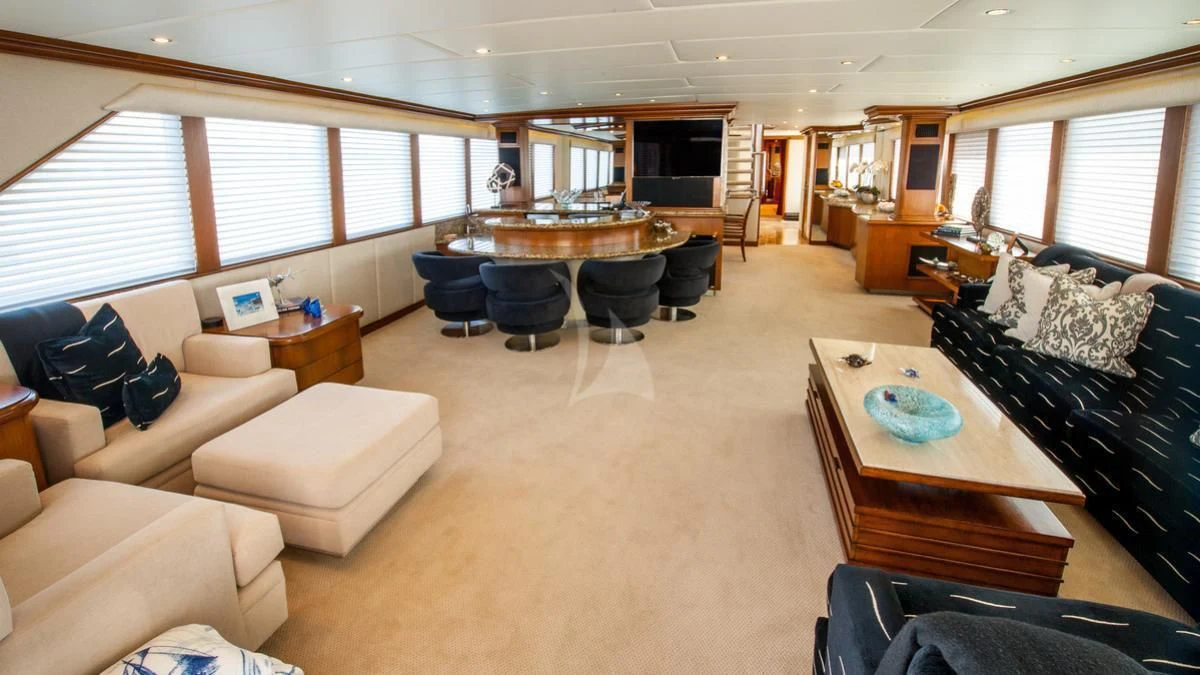 a living room with a couch and a table aboard SERENITY Yacht for Charter