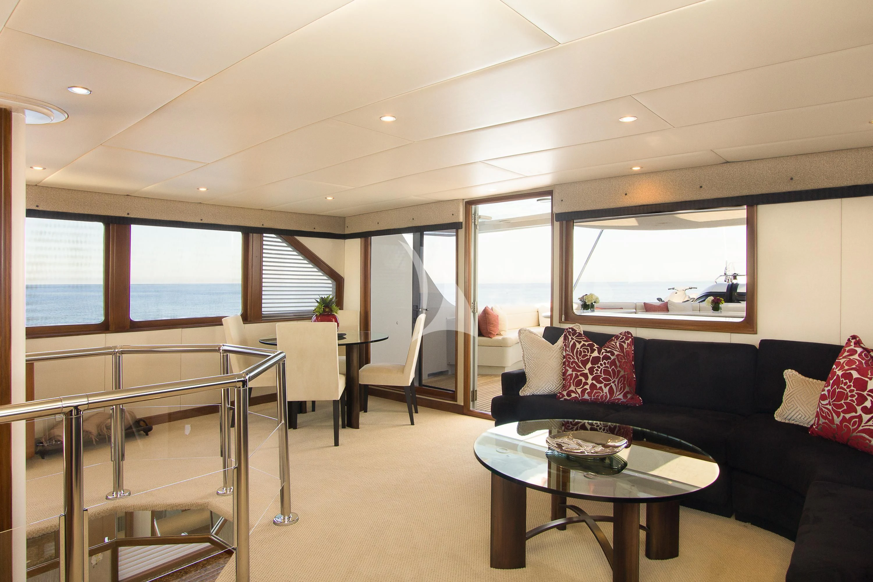 a living room with a black couch and a table aboard SERENITY Yacht for Charter
