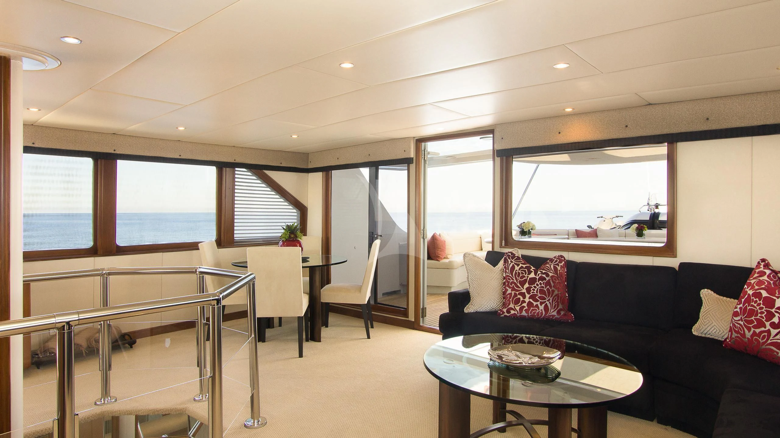 a living room with a black couch and a table aboard SERENITY Yacht for Charter
