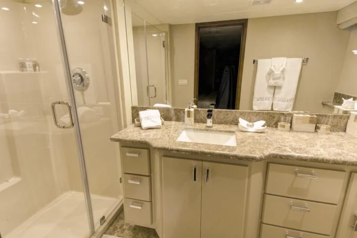 a bathroom with a countertop sink and a shower aboard SERENITY Yacht for Charter