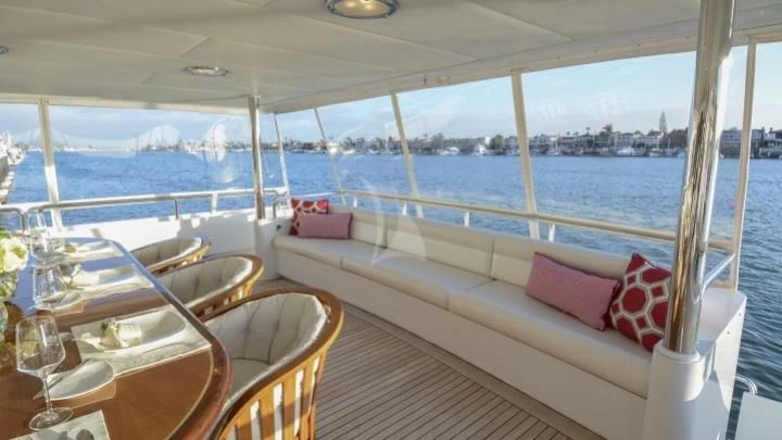 a room with a bed and a table and chairs aboard SERENITY Yacht for Charter