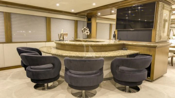 a room with a large round table and chairs aboard SERENITY Yacht for Charter