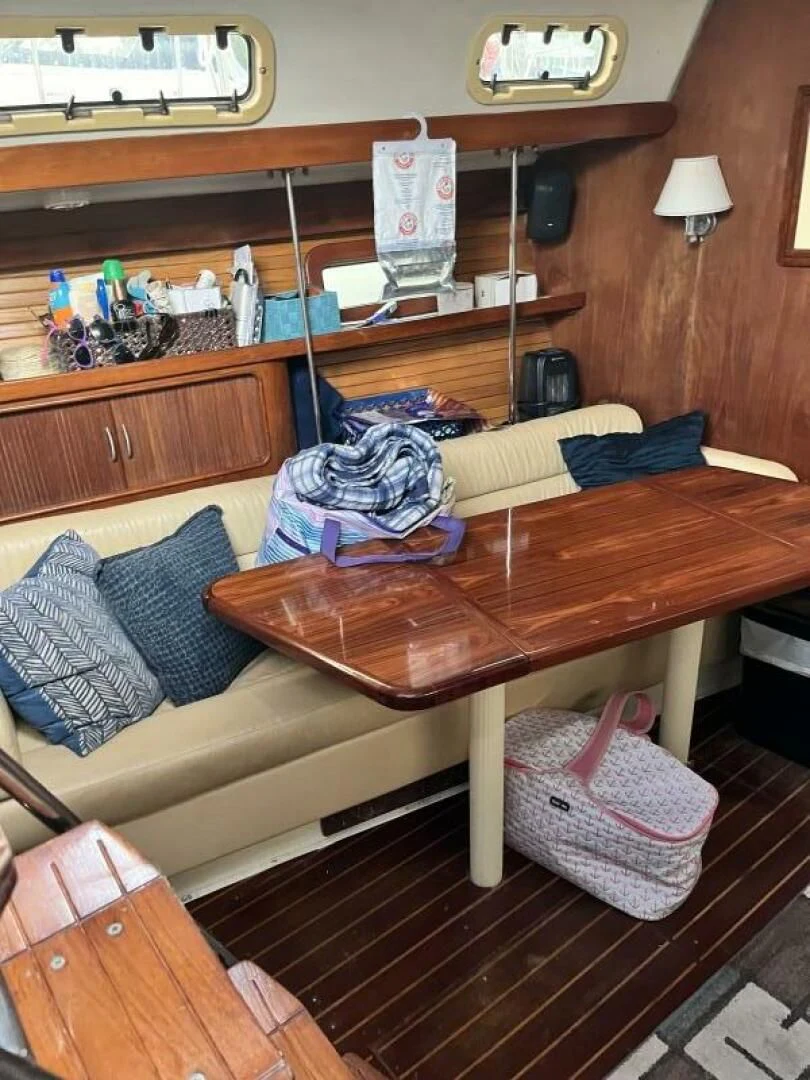 a wooden table with a shelf and a shelf with objects on it aboard SERENITY Yacht for Charter