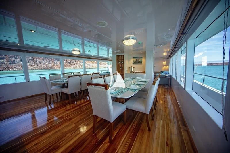 a room with a table chairs and a large window aboard GRAND DAPHNE Yacht for Charter