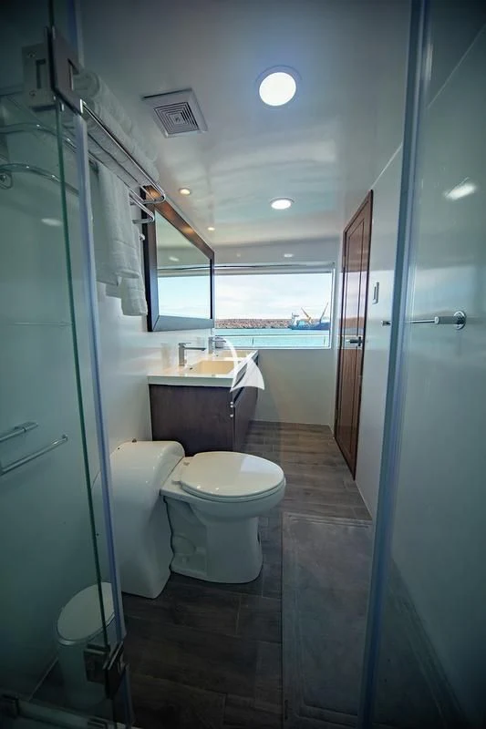 a bathroom with a glass shower door aboard GRAND DAPHNE Yacht for Charter