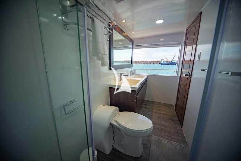 a bathroom with a glass shower door aboard GRAND DAPHNE Yacht for Charter