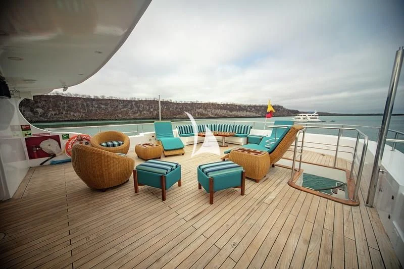 a deck with chairs and tables aboard GRAND DAPHNE Yacht for Charter