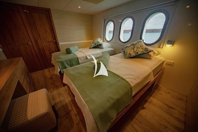 a couple of beds in a room aboard GRAND DAPHNE Yacht for Charter